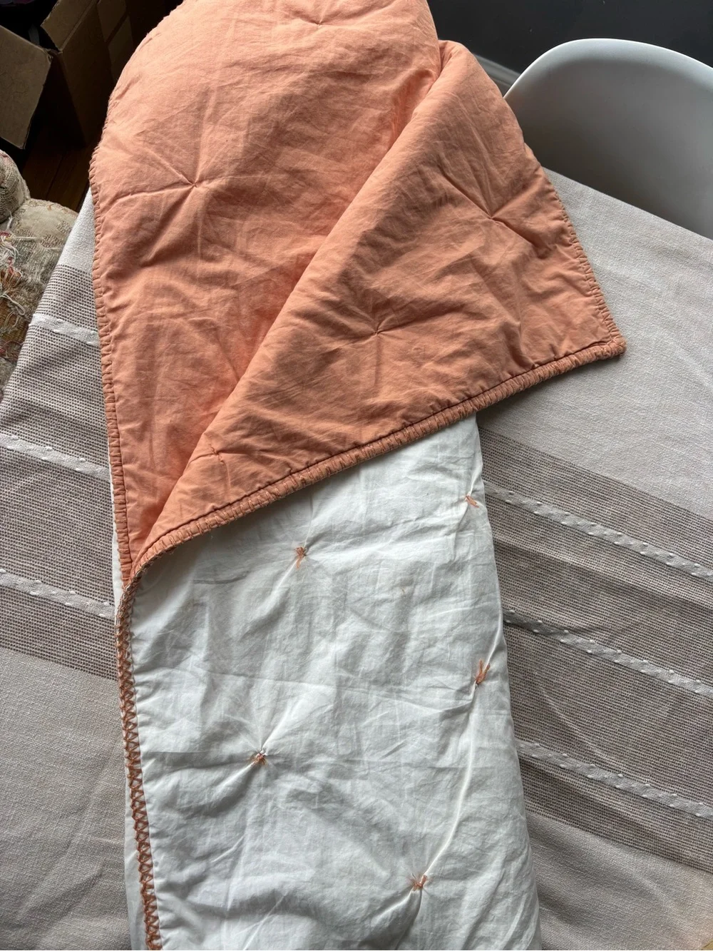 Crate and Barrel, Crate and Kids mini tufted crib quilt. Peach color